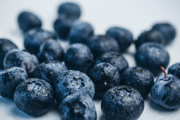 fresh blueberry berries on a white plate close-up. breakfast of wild berries. copy space