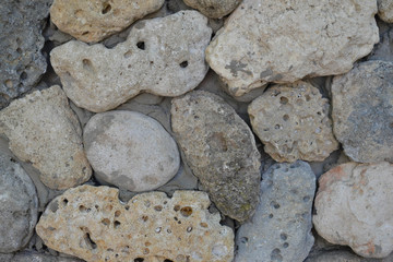 Gray stone wall of rough, natural stone, background texture.