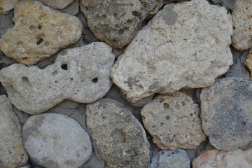 Gray stone wall of rough, natural stone, background texture.