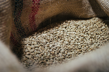 Roaster machine prepared coffee beans.  Process of coffee roasting in cafe. Ingridient for popular european drink. Brown bean inside box. Organic food. Close up shot.