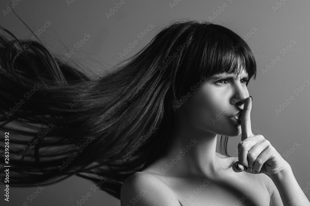 Wall mural professional care. black and white closeup portrait of emotional brunette girl found a secret of hai