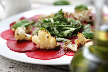Vegetable beetroot carpaccio with the addition of cauliflower and green lettuce.