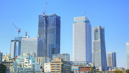 青空の下、建築中の高層ビルが立ち並ぶ横浜みなとみらいの都市風景