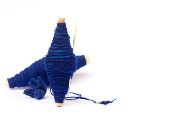 natural line of cotton thread wrap on small wooden core with a needle