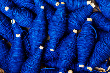 expertse craftmanship indigo dye blue color handmade natural line of cotton thread wrap on small...