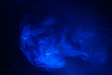 Blue smoke on black background.