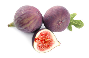 Whole and cut purple figs on white background, top view