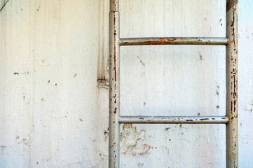 Fire Escape Metal Staircase with Grunge Concrete Wall Texture Background.