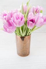 Pink Tulips in Bronze Vase. Vertical.