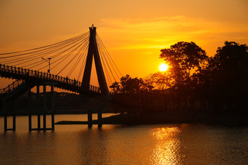 Fototapeta na wymiar Beautiful bridge wih lake and sunset gold color in the evening background
