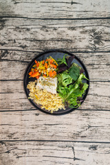 cod fish with vegetables, small vegetables and marine sauce