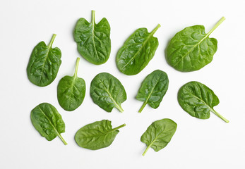 Fresh leaves of spinach isolated on white, top view