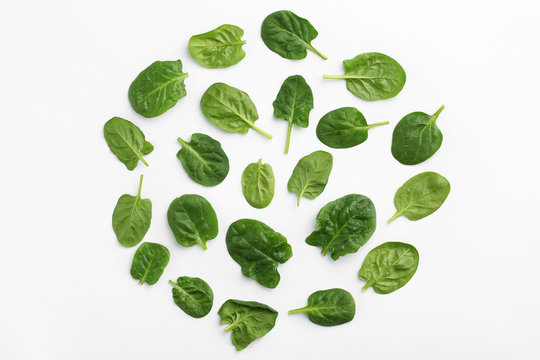 Fresh leaves of spinach isolated on white, top view