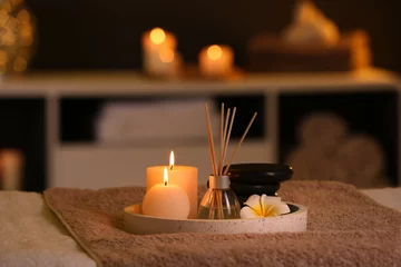 Foto op Canvas Burning candles and aromatic reed freshener on table in spa salon © New Africa