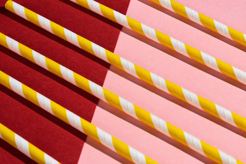 several yellow and white straws in retro style, close up top view