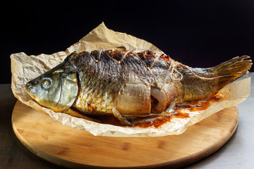 Carp stuffed with baked fruit, sewn with thread.