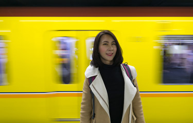Irene Portrait capture with the moving train as background. Camera aloft, capture the precious moment, a yellow train was passing, create a dynamic and static picture.