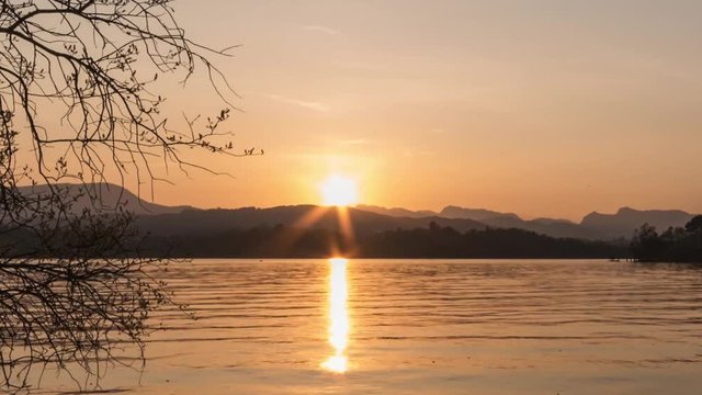 Sunset over lake closeup time lapse