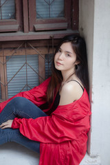 Fototapeta premium asia thai teen red coat on street fashion
