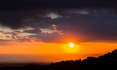 This is a capture of a sunset in Beirut and you can see the orange color formed by the sun and the...