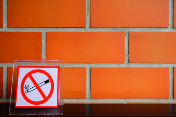 No Smoking Sign with Brick Wall Background in Coffee Shop.