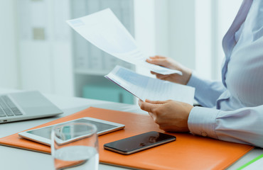 Business executive checking financial reports in the office