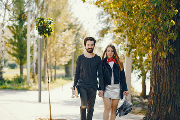 Obraz premium young hipsters standing in a summer sunny park with a skateboard in their hands
