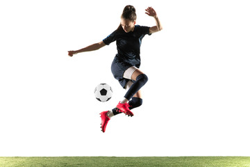 Female soccer player kicking ball isolated over white background © master1305