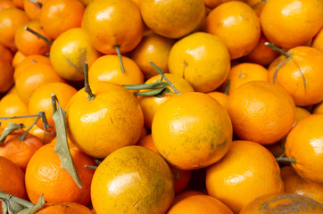 orange fruit stacked on the marketplace