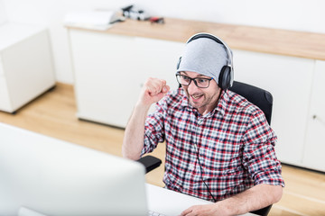 Happy gamer at his desktop computer.