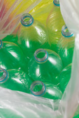 A pack of 8 empty and recyclable plastic water bottles, with no caps, blue seal, inside a plastic bag, on a  colored background. garbage, Reuse, Eco-Friendly, Environment concept.