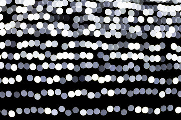 Abstract bokeh of white city lights on black background. defocused and blurred many round light
