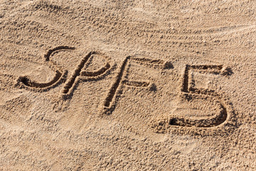 Sun protect factor five concept. SPF 5 word written on the beach