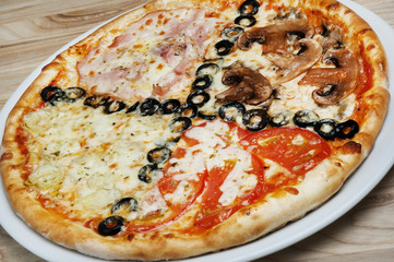 Delicious pizza with cheese, mushrooms, olives and tomatoes on a wood background