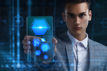 The concept of business, technology, the Internet and the network. A young entrepreneur working on a virtual screen of the future and sees the inscription: ISO 9001