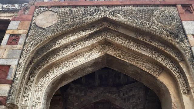 tilt up gimbal shot walking towards of the medieval monument bara gumbad at lodhi gardens in delhi, india