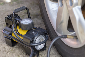 car compressor next to the car pumping wheels
