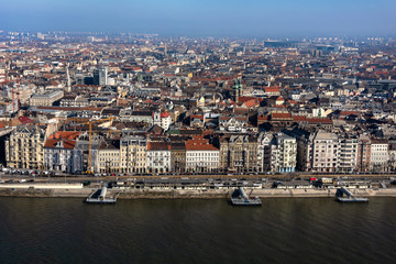 Obraz premium Hungary, Budapest: Skyline from above with Danube Donau river pier, mass of buildings, apartments, rooftops in the city center of the Hungarian capital - concept urban development.
