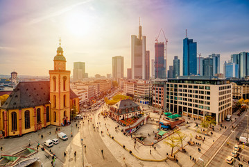 View to skyline of Frankfurt am Main during sunset. St. Catherine's Church and the Hauptwache Main Guard building with famous Frankfurt skyscrapers. Center of Frankfurt in Germany. - obrazy, fototapety, plakaty