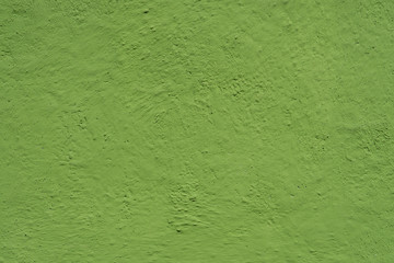 Wall painted in green. Bright green grungy background.