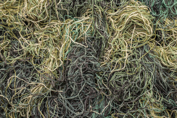 background of colored threads chaotically intertwined. green yellow and brown threads matted in a colorful background