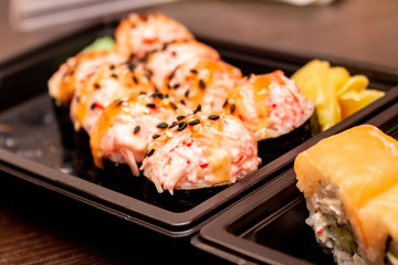 Fresh sushi and rolls fast food in a box close up