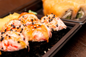 Fresh sushi and rolls fast food in a box close up