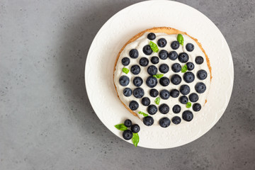 Angel food cake with whipped cream, fresh blueberries and basil. 