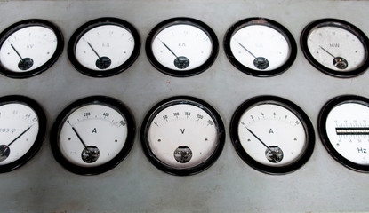 Details of an old black analog ampere meter.