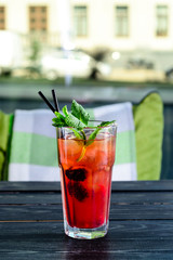 Party and holiday celebration concept. strawberry cocktail decorated with cherry in the restaurant table close up view