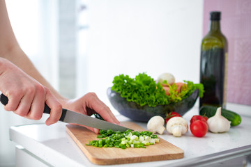 Chopping vegetables on cutting board for fresh salad at kitchen at home. Cooking preparation for dinner. Clean healthy food and proper nutrition. Diet