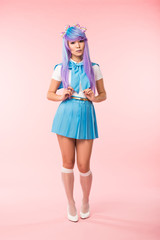 Full length view of sad asian anime girl in skirt standing on pink