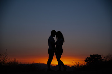 Fototapeta na wymiar Young couple enjoying the sunset.