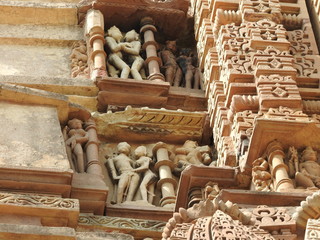 Fototapeta premium Sex poses from the kamasutra, erotic close - up of intricate carved scenes on the walls of Hindu temples in the Western group of Khajuraho, India